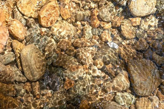 Clear water in the river and stone texture background