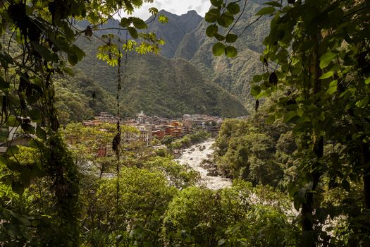 Aguas Calientes, Peru - April 5, 2014: View of the town of Aguas Calientes, surrounded by mountains and tropical jungle, next to the Vilcanota River, near Machu Picchu, Peru.