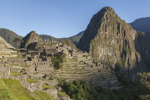 Machu Picchu, Peru - April 6, 2014: View of the sunrise over Machu Picchu, in the background, the sacred mountain Huayna Picchu, Peru.