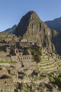 Machu Picchu, Peru - April 6, 2014: View of the sunrise over Machu Picchu, in the background, the sacred mountain Huayna Picchu, Peru.