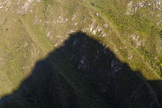 Machu Picchu, Peru - April 6, 2014: The silhouette shadow of the sacred mountain Huayna Picchu, close to the Machu Picchu, Peru.