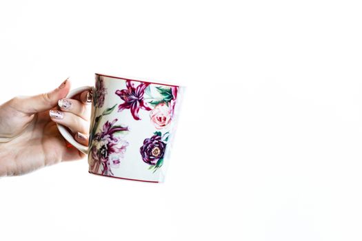 Woman hand holding a cup isolated on white background.