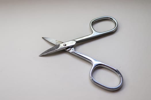 Manicure scissors closeup on white background