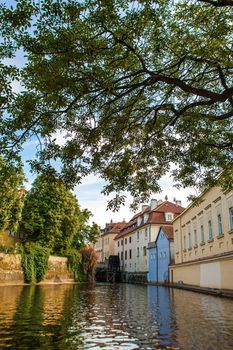 The architecture of the strago city of Prague. River channel in the city. Streets of old Europe, cityscape.