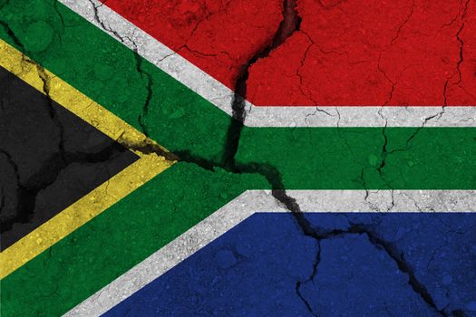 South Africa flag on the cracked earth. National flag of South Africa. Earthquake or drought concept
