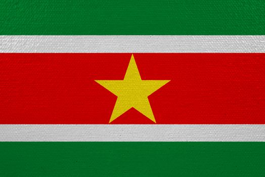 Suriname flag on canvas. Patriotic background. National flag of Suriname