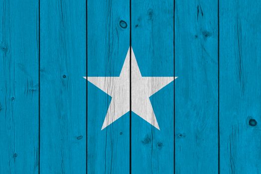 Somalia flag painted on old wood plank. Patriotic background. National flag of Somalia