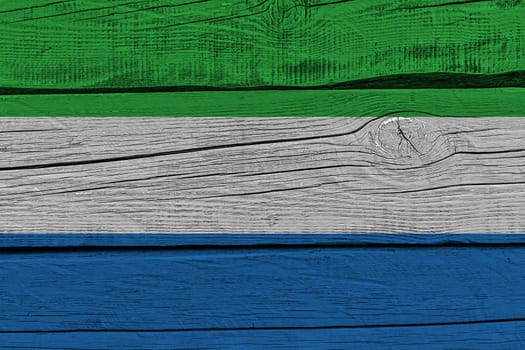 Sierra leone flag painted on old wood plank. Patriotic background. National flag of Sierra leone