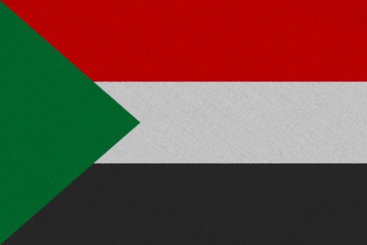 Sudan fabric flag. Patriotic background. National flag of Sudan