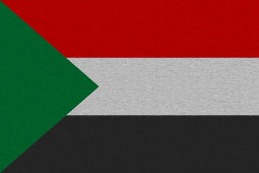 Sudan flag painted on paper. Patriotic background. National flag of Sudan