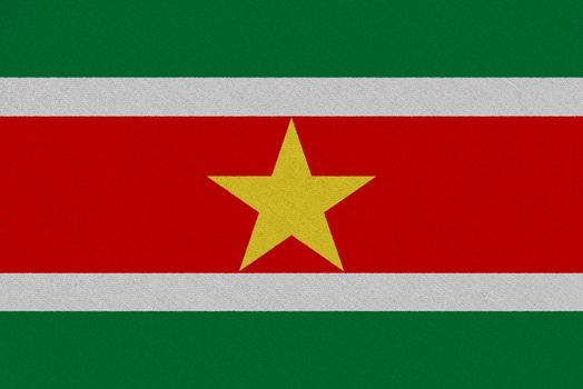 Suriname fabric flag. Patriotic background. National flag of Suriname