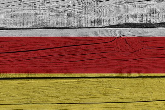 South ossetia flag painted on old wood plank. Patriotic background. National flag of South ossetia