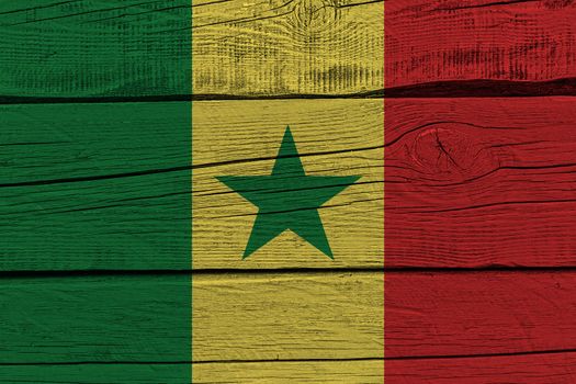 Senegal flag painted on old wood plank. Patriotic background. National flag of Senegal