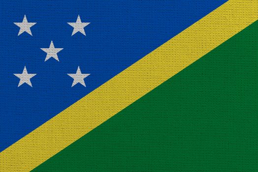 Solomon Islands fabric flag. Patriotic background. National flag of Solomon Islands