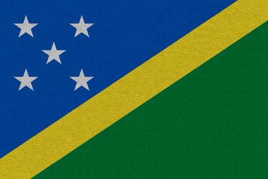 Solomon Islands flag painted on paper. Patriotic background. National flag of Solomon Islands