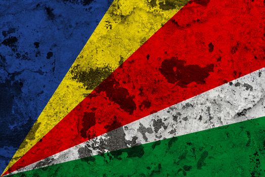 Seychelles flag on old wall. Patriotic grunge background. National flag of Seychelles