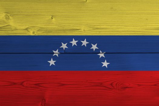 Venezuela flag painted on old wood plank. Patriotic background. National flag of Venezuela
