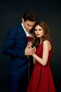 luxury couple hug romance relationship rose over dark isolated background. High quality photo