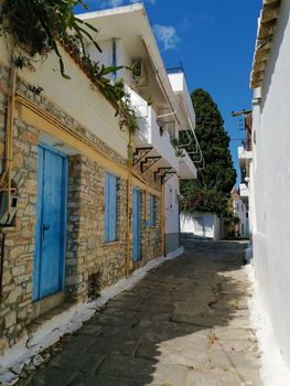 Street in ermioni peleponnese greece. Greek town road or alley, house with blue door