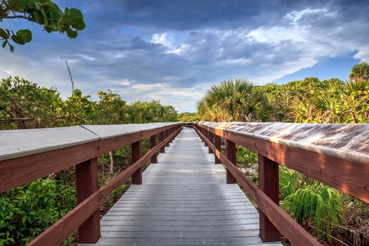 Boardwalk leads down to the white sand of Barefoot Beach in Bonita Springs, Florida