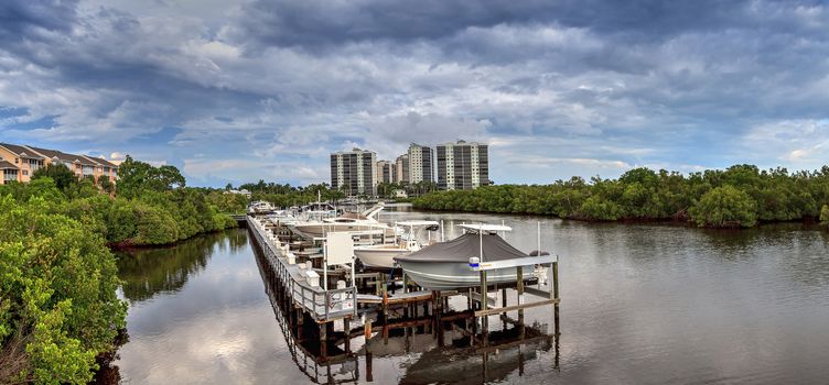 Boats docked in a harbor along the Cocohatchee River in Bonita Springs, Florida