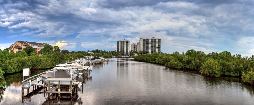 Boats docked in a harbor along the Cocohatchee River in Bonita Springs, Florida