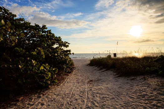 Pathway leads down to the white sand of Barefoot Beach in Bonita Springs, Florida
