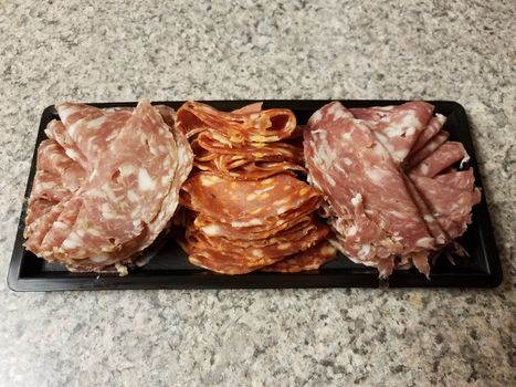 container of sliced salami meat snacks on counter