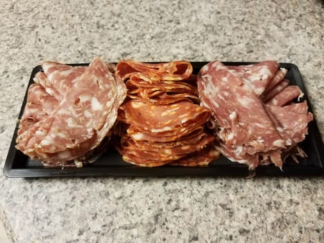 container of sliced salami meat snacks on counter