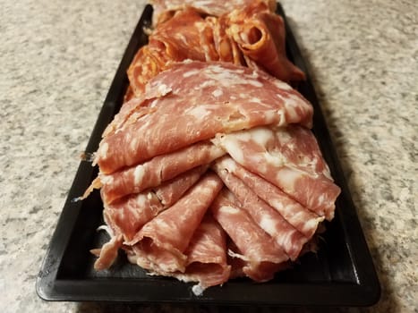 container of sliced salami meat snacks on counter