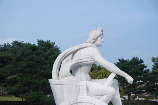 White marble stone statue of sitting Poseidon or Neptune