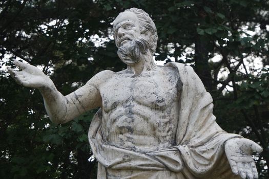 The ancient marble portrait of man with beard placed in a public park