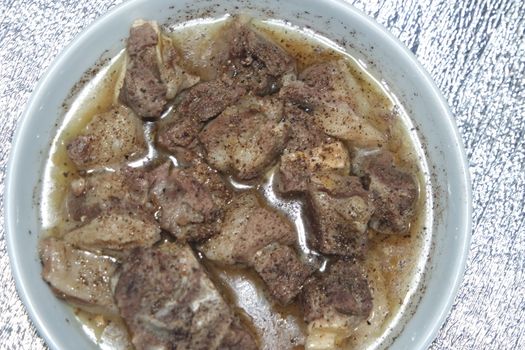 Top view of siri paaye or paya dish garnished with diced ginger, long coriander and black pepper. This dish is popular in Pakistan and Bangladesh