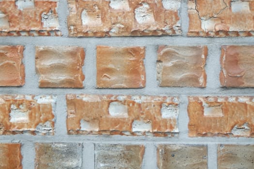 Closeup texture of black brick wall. A background of a weathered old exterior brick wall in the sunshine.