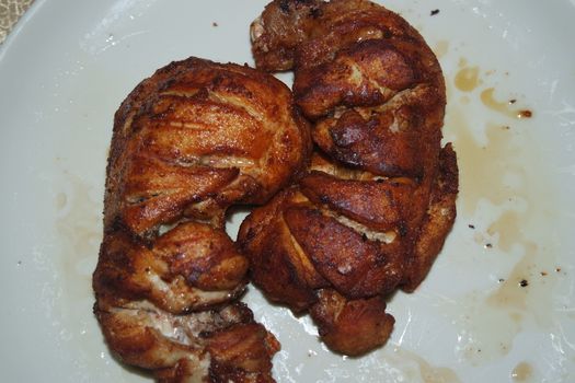 Fried, grilled baked chicken pieces with marinated spices on it. Tasty delicious fried chicken barbecue