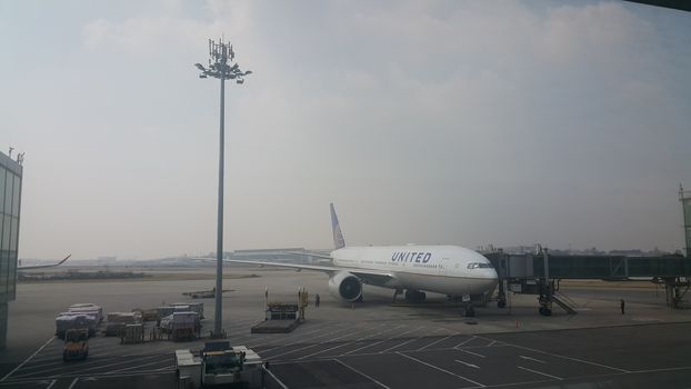 Beijing Airport, china- April 2019: Passenger plane standing in airport on the concrete paved runway terminal for loading, boarding and maintenance before take off for predestined flights.
