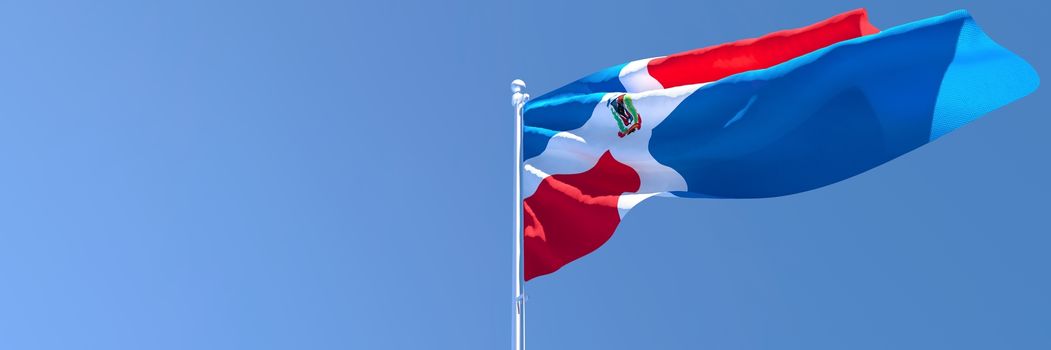 3D rendering of the national flag of Dominican Republic waving in the wind against a blue sky