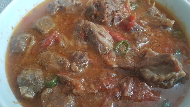 A close up view of stewed chicken meat cubes with spices on it, a traditional home made delicious chicken meat dish