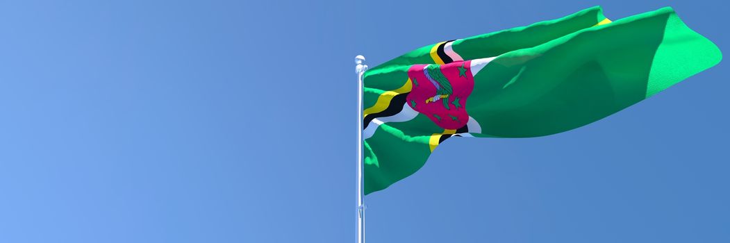 3D rendering of the national flag of Dominica waving in the wind against a blue sky