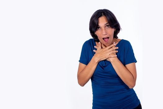 Black-haired woman with her arms crossed on her chest and a shocked expression on her face.