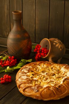 Apple and rowan pie on dark wooden table