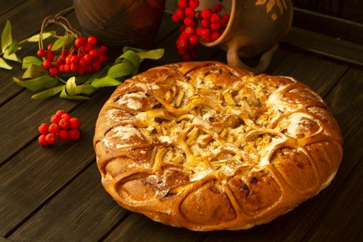 Traditional homemade pumpkin autumn pie decorated by apple and rowan berries