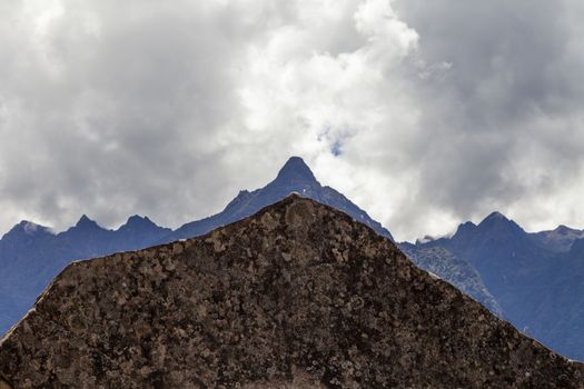 Machu Picchu, Peru - April 6, 2014: The sacred rock and monolith of Machu Picchu, silhouetted against the mountain line, Peru.