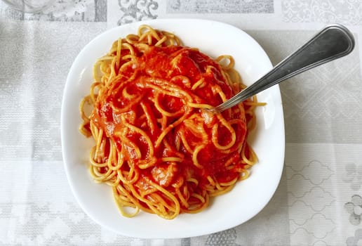 top view of plate of spaghetti with tomato sauce. Italian food. Portion of pasta.