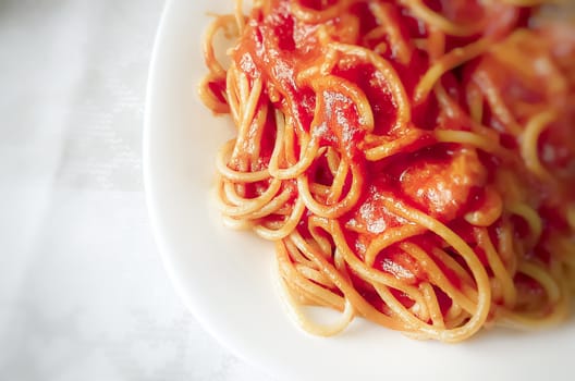 Close up of a plate of spaghetti with tomato sauce. Italian food. Portion of pasta.