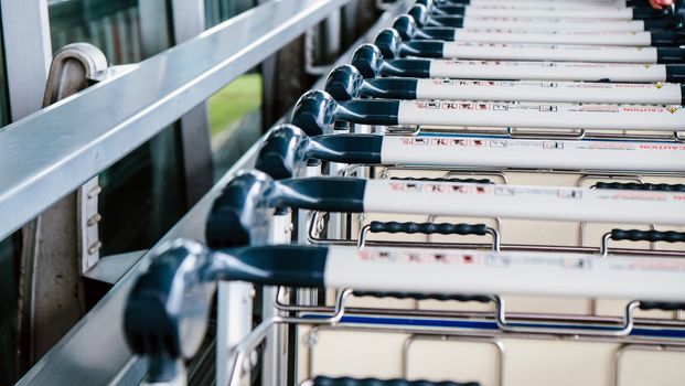 Image of Luggage trolley in a row at the airport