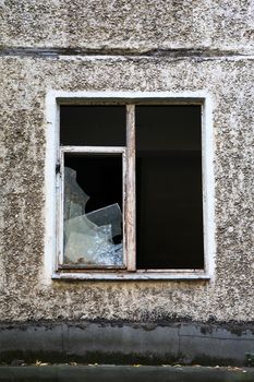 Eviction concept. Old abandoned building with shattered windows