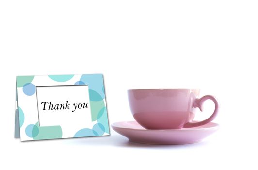 Pink porcelain cup of tea with thank you card on white background. Card, poster, mock up. Celebrating, anniversary, birthday concept.