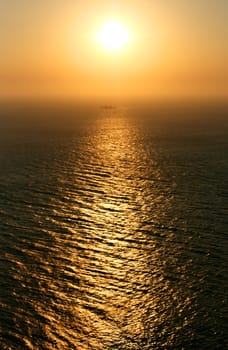 Sun flare path on the surface of the water in the sea. Sunset.