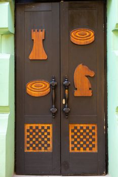 Stylish themed entrance door to the chess club building.